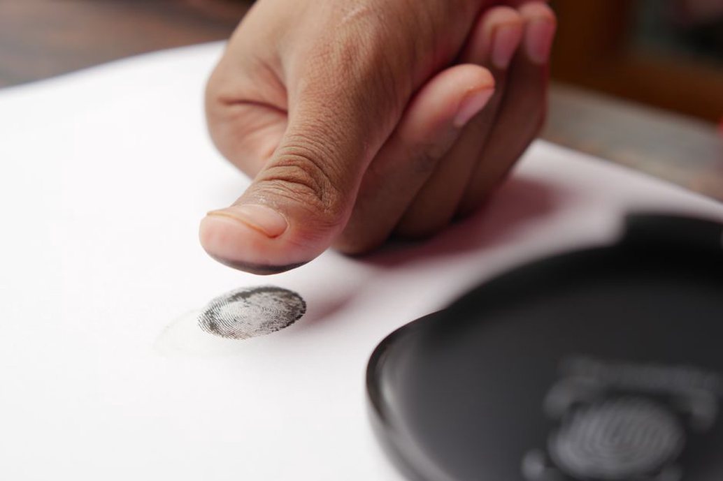 A biometric fingerprint scanner being used for identification