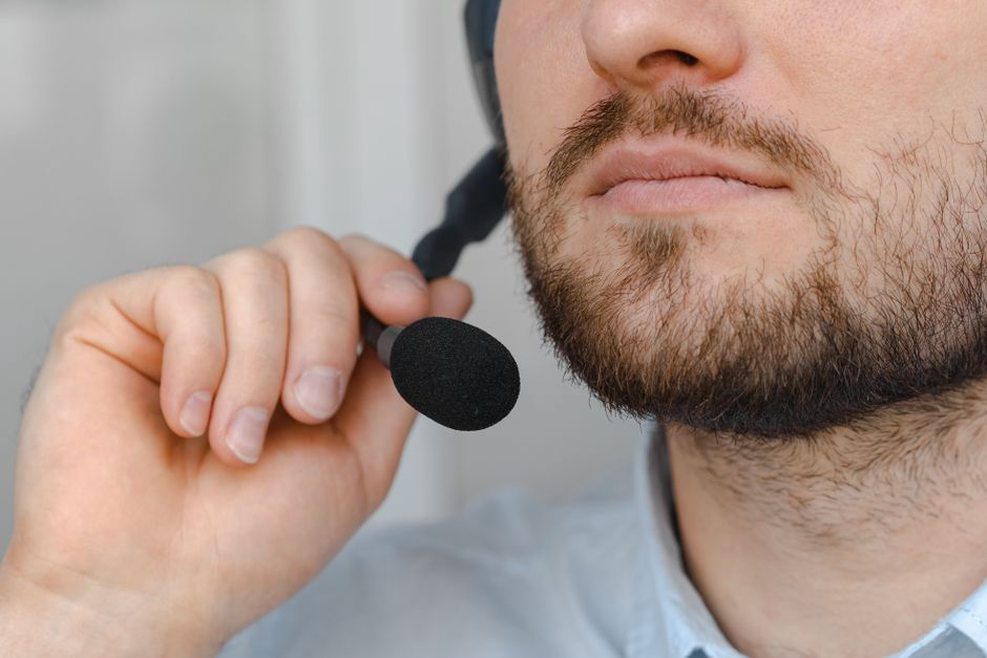 Contact microphone attached to a speaker's neck for speech capture