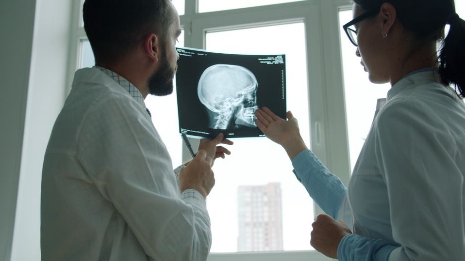 A team of radiologists discussing patient scans in a clinical setting