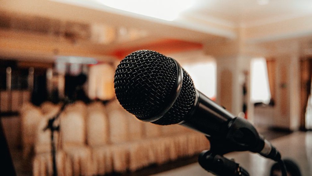 Researchers discussing speech synthesis at a conference