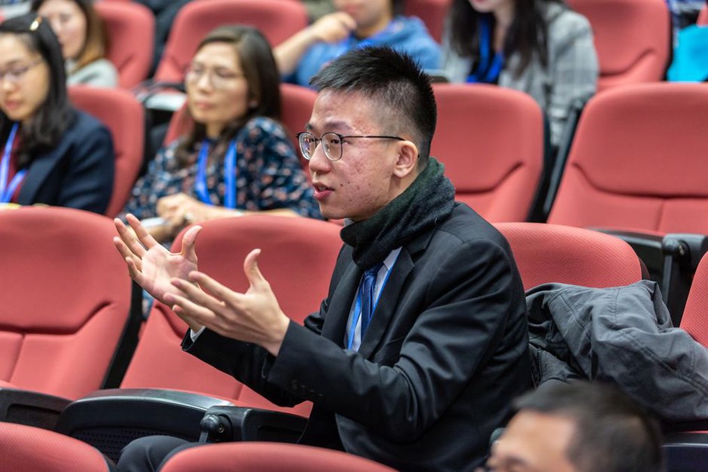 Researchers discuss results after a technical presentation
