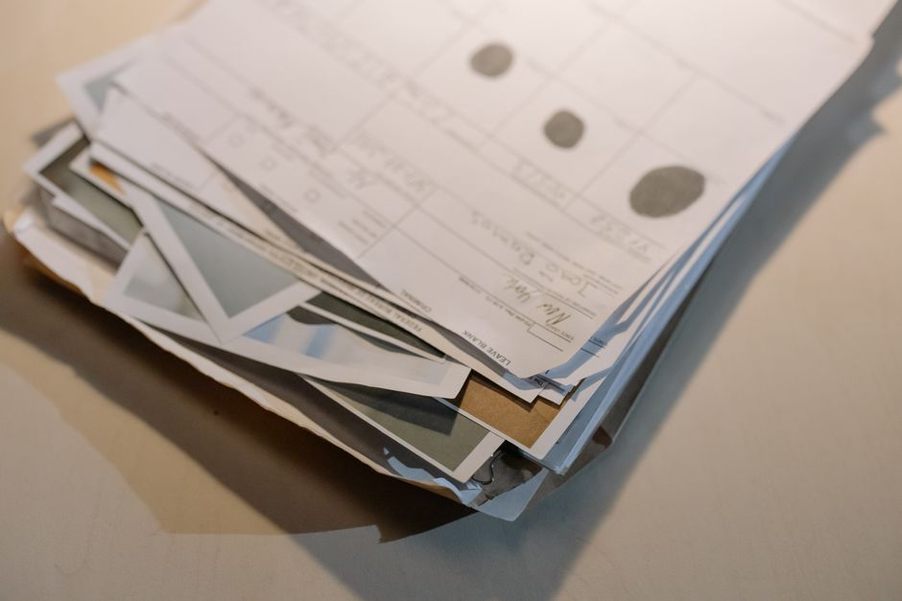 Paper forms arranged beside a document scanner