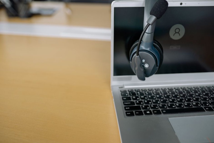 Researcher reviewing a speech transcript beside recorded audio