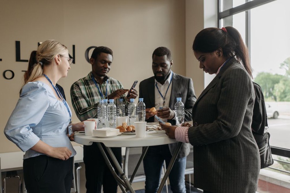 Researchers networking at an AI conference