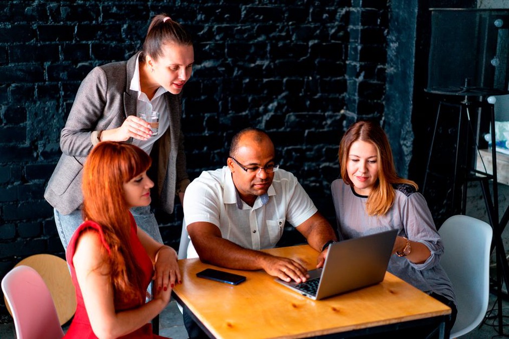 Scientists collaborating at a tech event, illustrating interdisciplinary teamwork