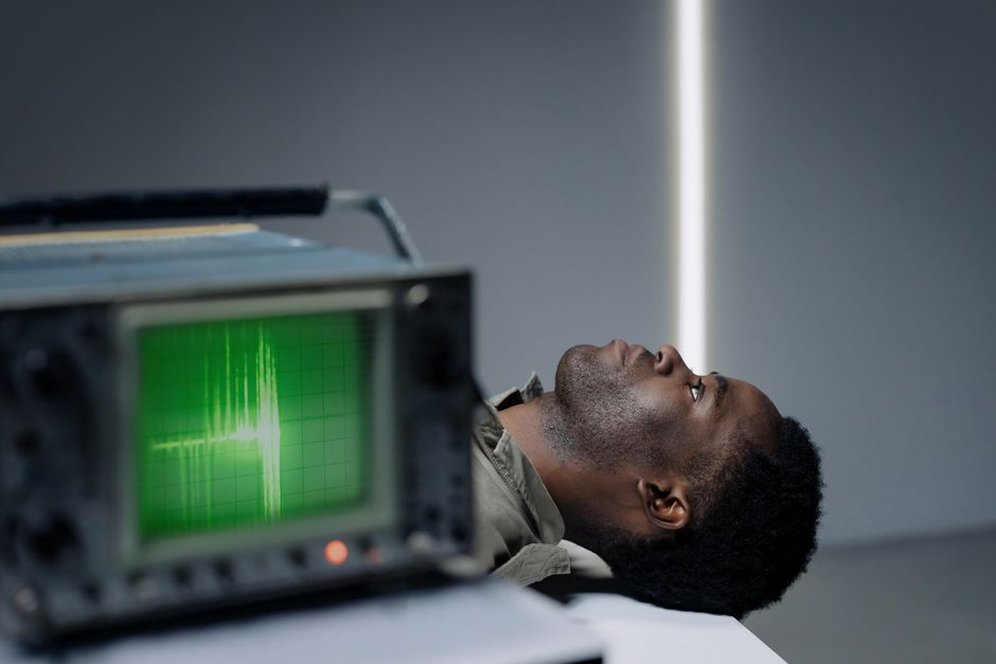 Researcher examining speech waveforms on an older workstation