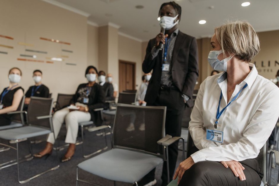 Researchers discussing advancements at a scientific conference
