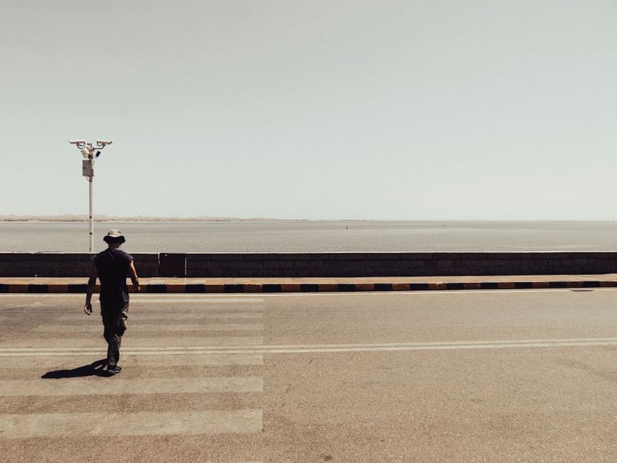 A pedestrian briefly hidden by a pillar