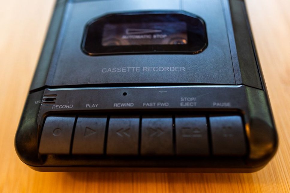 handheld cassette recorder next to field notes during language documentation work