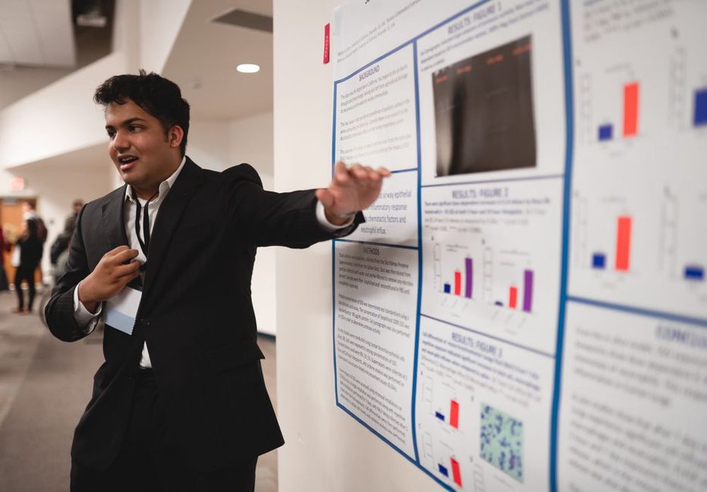Researchers discussing at a scientific conference