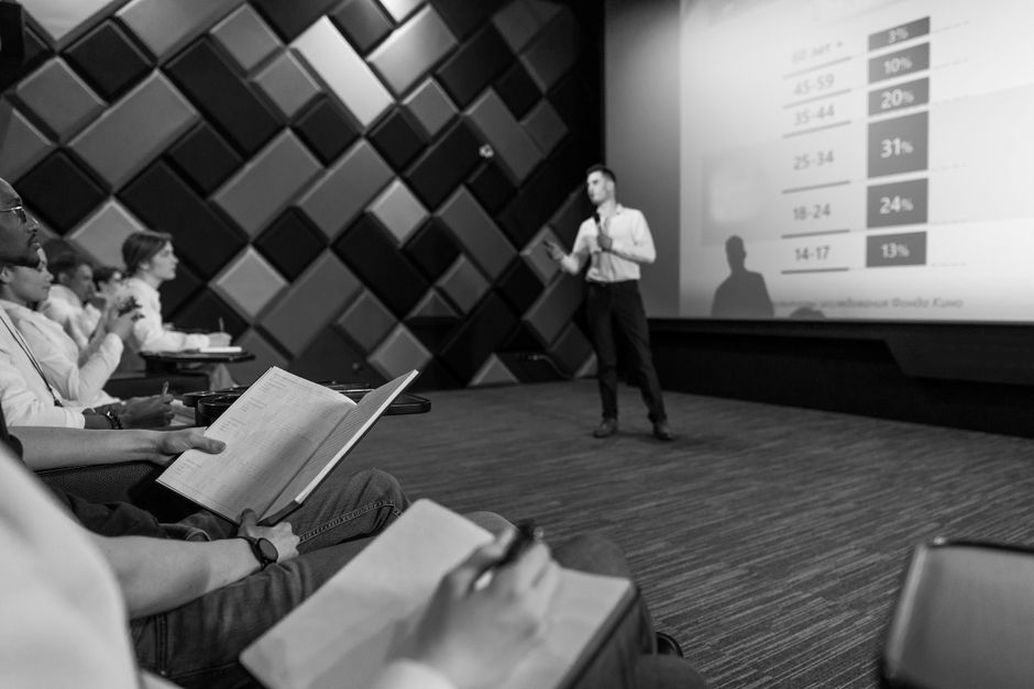 Researchers listening to a conference presentation