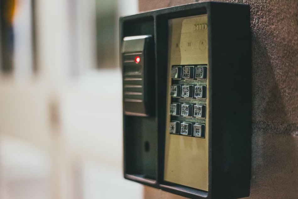 A finger rests on an access-control scanner
