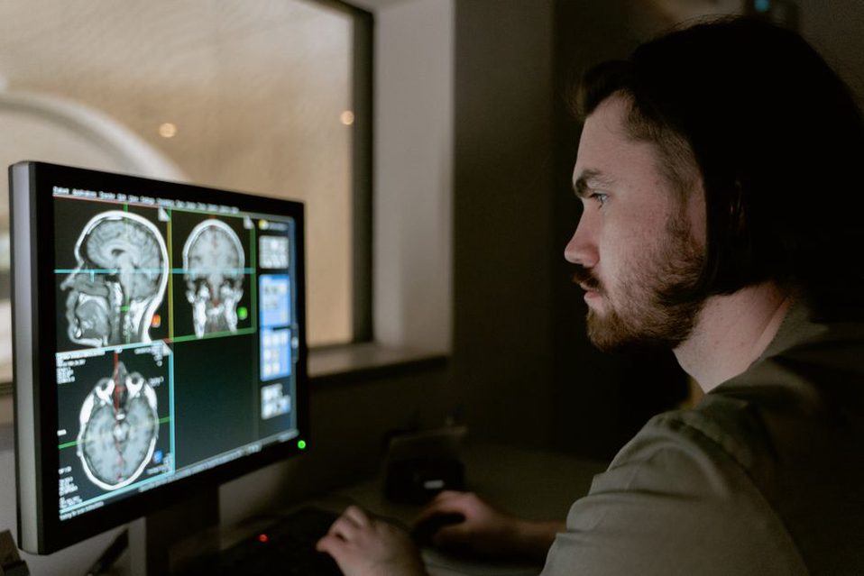 Brain MRI slices arranged across a diagnostic display